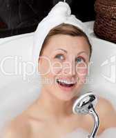 Jolly young woman having a bath