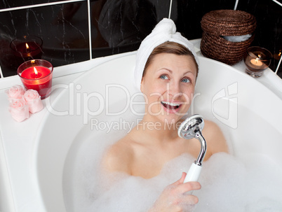 Beautiful woman singing while having a bath