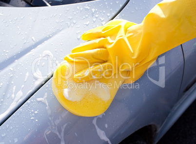 Woman cleaning a car