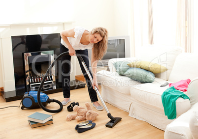 Portrait of a bored woman vacuuming