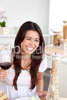 Delighted  woman drinking red wine