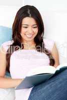 Portrait of a smiling woman reading a book