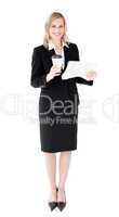 A beautiful businesswoman holding a cup of coffee reading a news