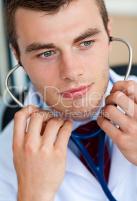 Portrait of an assertive male doctor holding a stethoscope