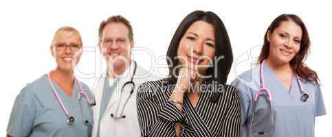 Hispanic Woman with Male and Female Doctor or Nurse