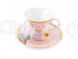 Pink tea cup on a saucer and a tea bag