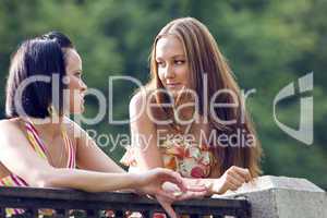 Two young woman in park