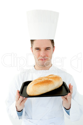 A male cook  holding  bread looking at the camera against white