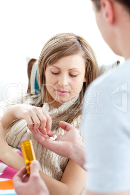 Boyfriend giving his sick girlfriend pills