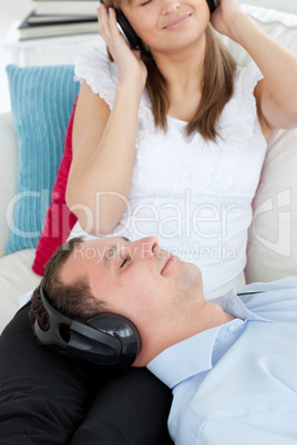 Close-up of a man listening to music lying on the sofa with his