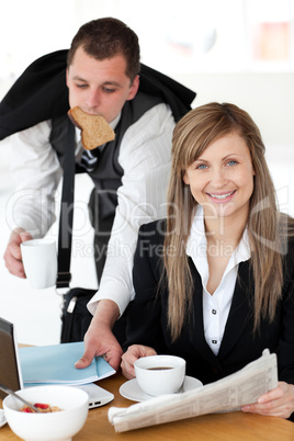Delighted businesswoman with a cup smiling at the camera