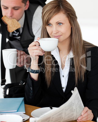 Beautiful businesswomand drinking  coffee while her husband hurr