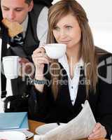Beautiful businesswomand drinking  coffee while her husband hurr