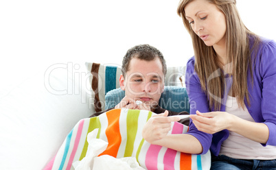Caring woman check the temperature of her sick boyfriend with a