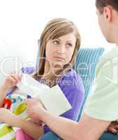 Assertive man giving his ill girlfriend tissue