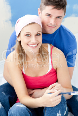 Portrait of a loving couple after painting a room