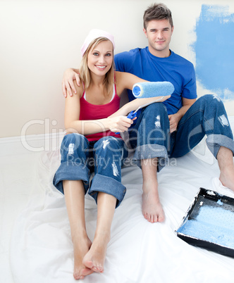 Affectionate couple painting together a room
