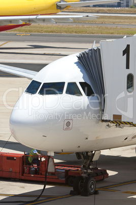 Airplane at an Airport With Passenger Gangway In Position