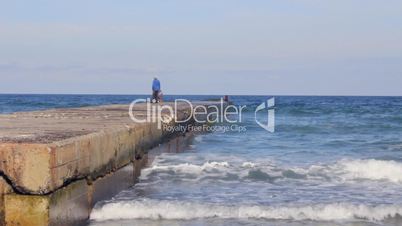 Fishermen on the pier in the sea (Full HD)