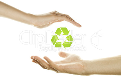 Hands protecting the recycling symbol.