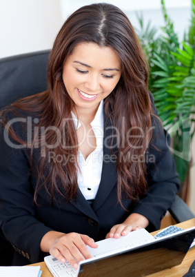 Confident businesswoman with a laptop smiling