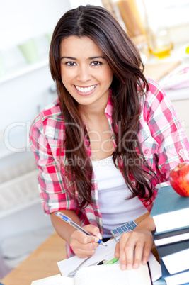 Portrait of a smiling  caucasian teen girl studying