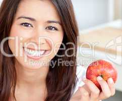Smiling young woman holding a red an apple