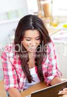 Caucasian young woman is using a laptop