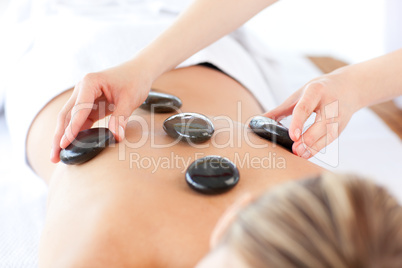 Relaxed woman having a stone therapy