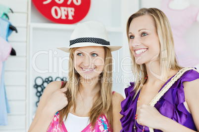 Confident women choosing clothes together