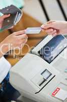 Close-up of a teen woman paying with her credit card