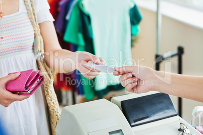 Close-up of a caucasian woman paying with her credit card