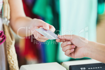 Close-up of a woman paying with her credit card