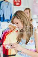 Happy women choosing clothes together