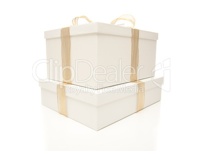 Stacked White Gift Boxes with Gold Ribbon Isolated