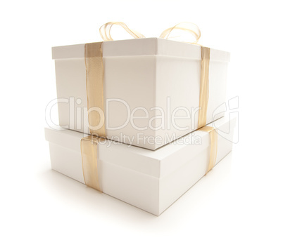 Stacked White Gift Boxes with Gold Ribbon Isolated