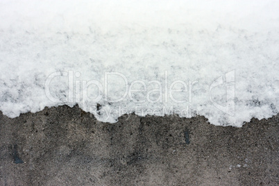 Snow over concrete wall