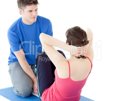 Attractive man doing fitness exercises with a woman