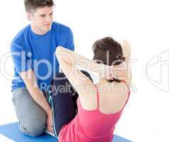 Attractive man doing fitness exercises with a woman
