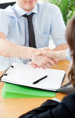 Handsome businessman in front of his desk