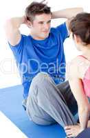 Young man doing fitness exercises with a woman