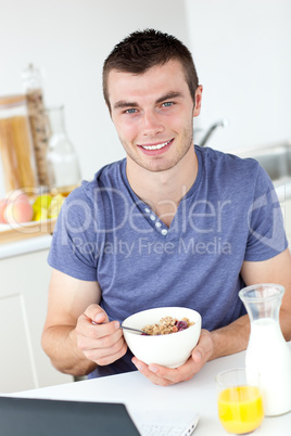 Charming man having breakfast