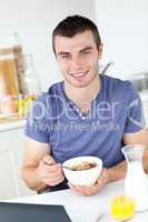 Charming man having breakfast