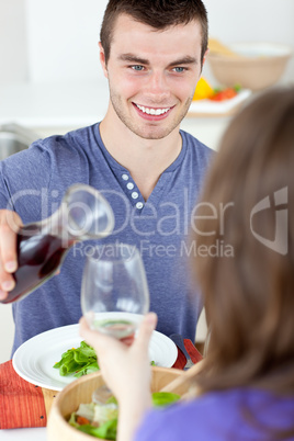 Young man eating with woman
