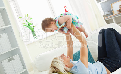 Merry mother playing with her daughter