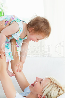 Radiant mother playing with her daughter
