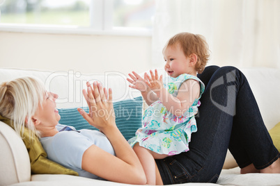 Attractive mother playing with her daughter