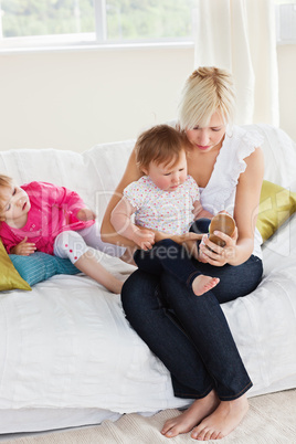 Pretty mother playing with her daughters