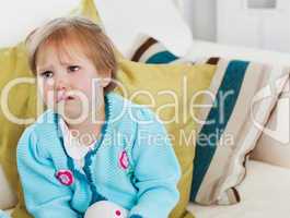 Small girl crying on sofa