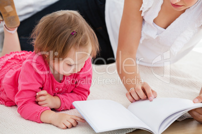 Kind mother reading a book with children